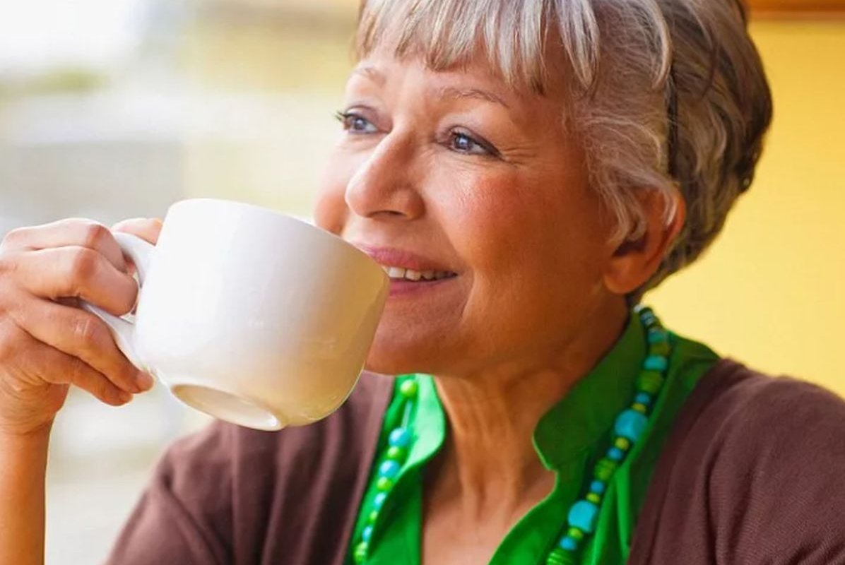 a woman drinks from a cup