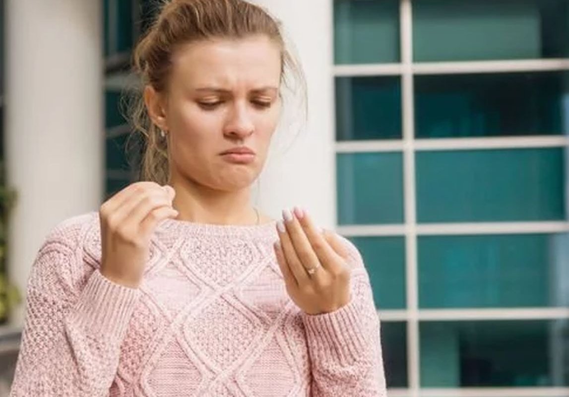 a girl examines her nails