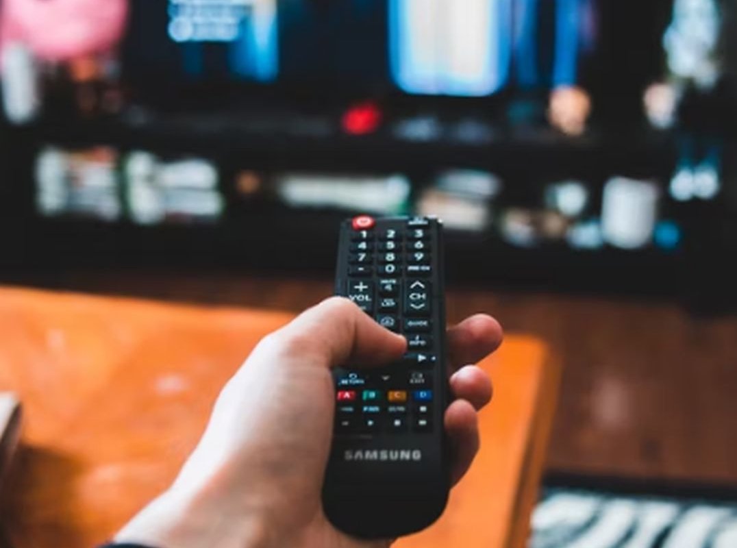 TV remote control in hand