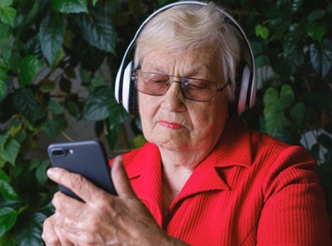 an elderly woman with headphones