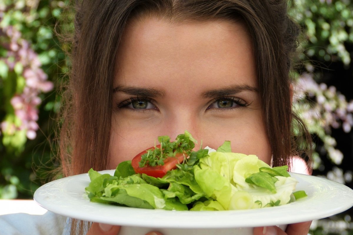 a girl eats a salad