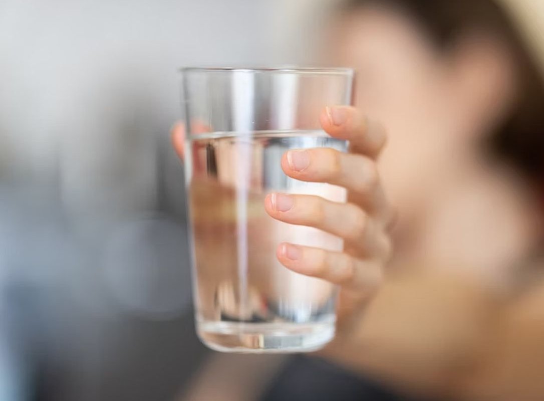 a glass of water in the hand