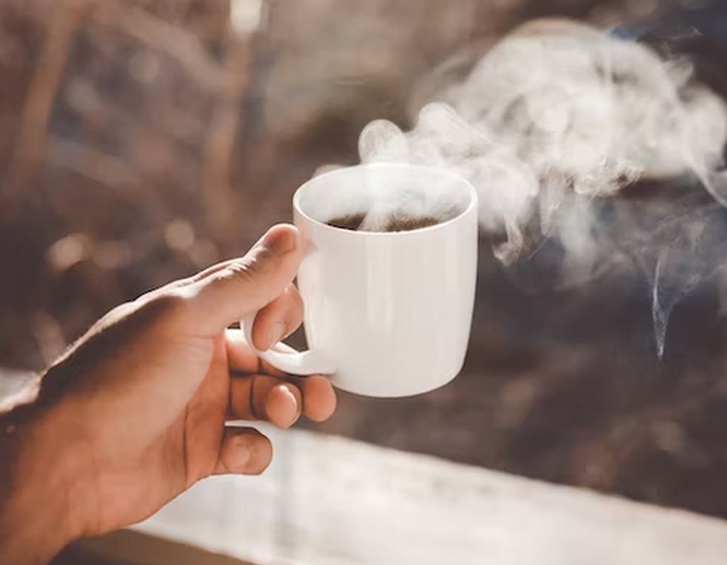 mug with drink in hand