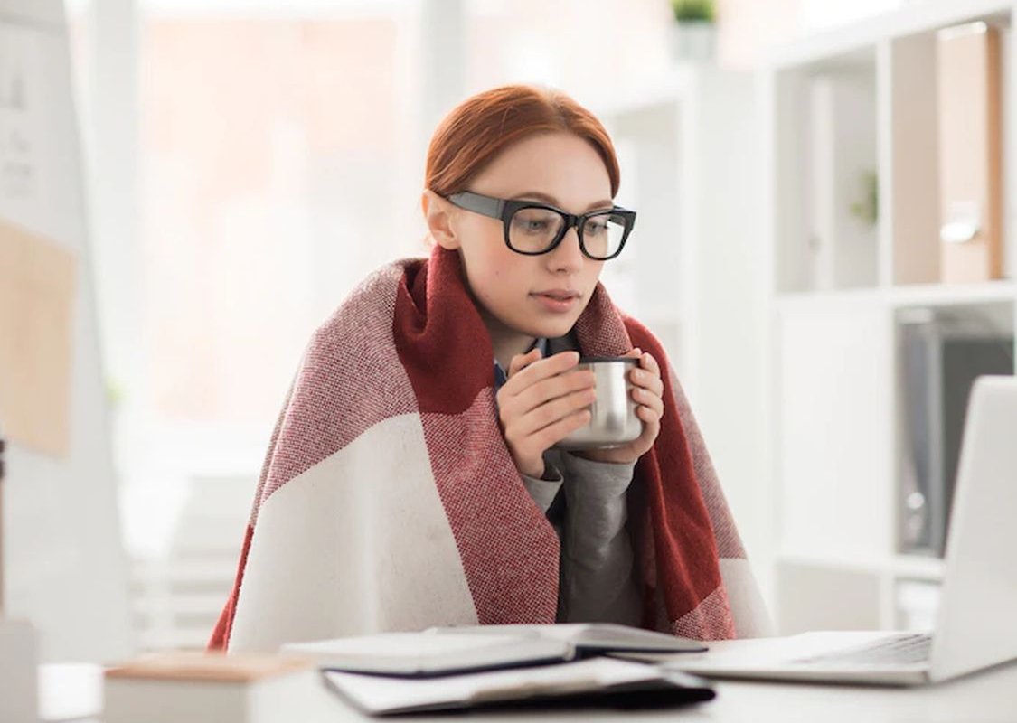 a woman gets cold in the office