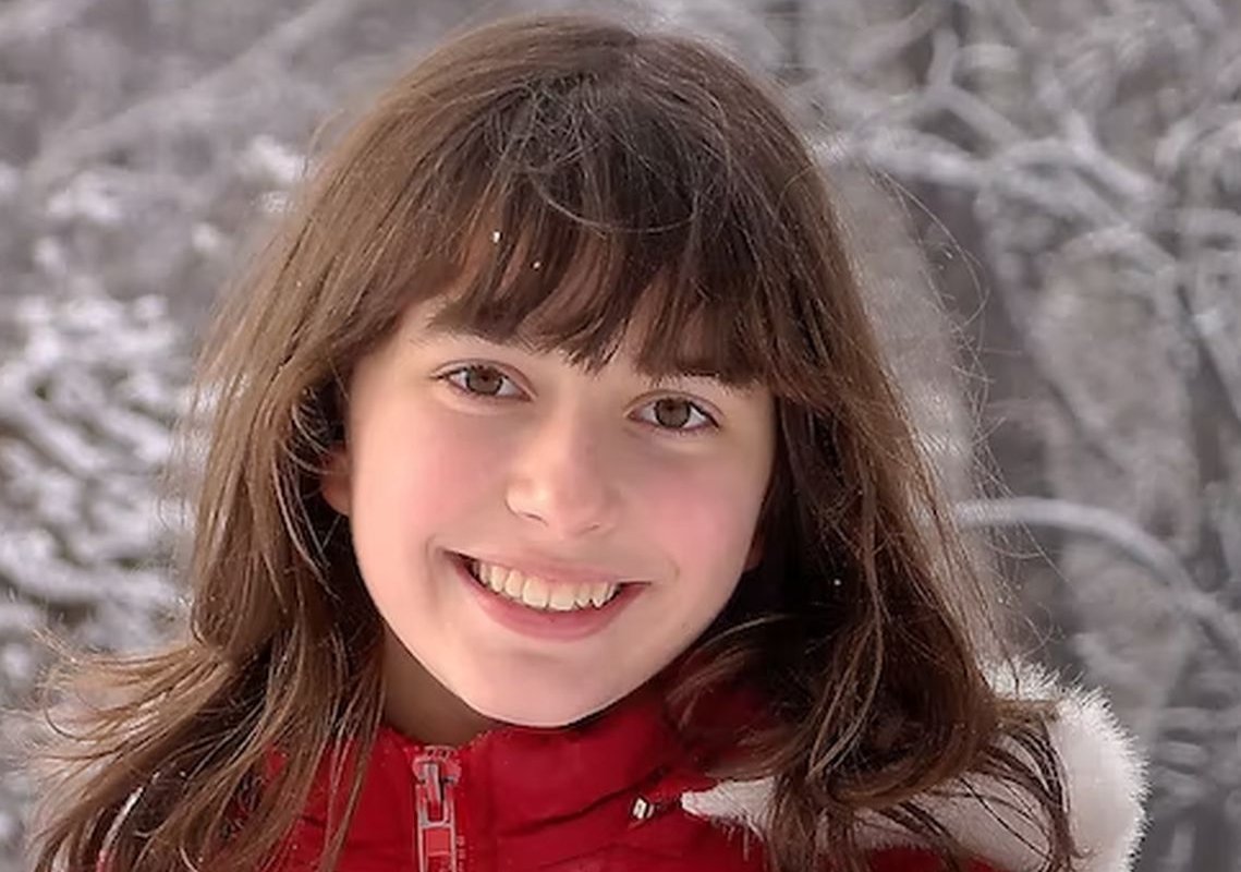 the girl smiles at the winter landscape