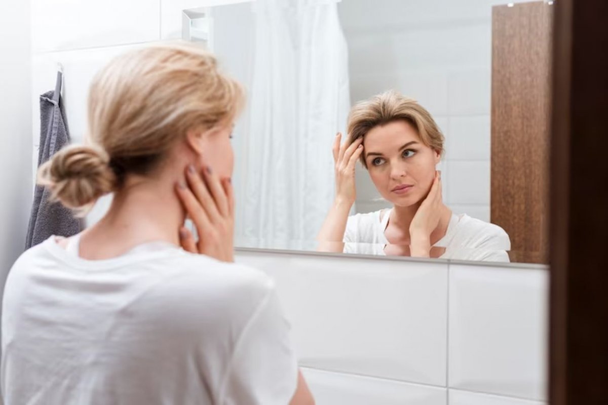 a woman in front of a mirror