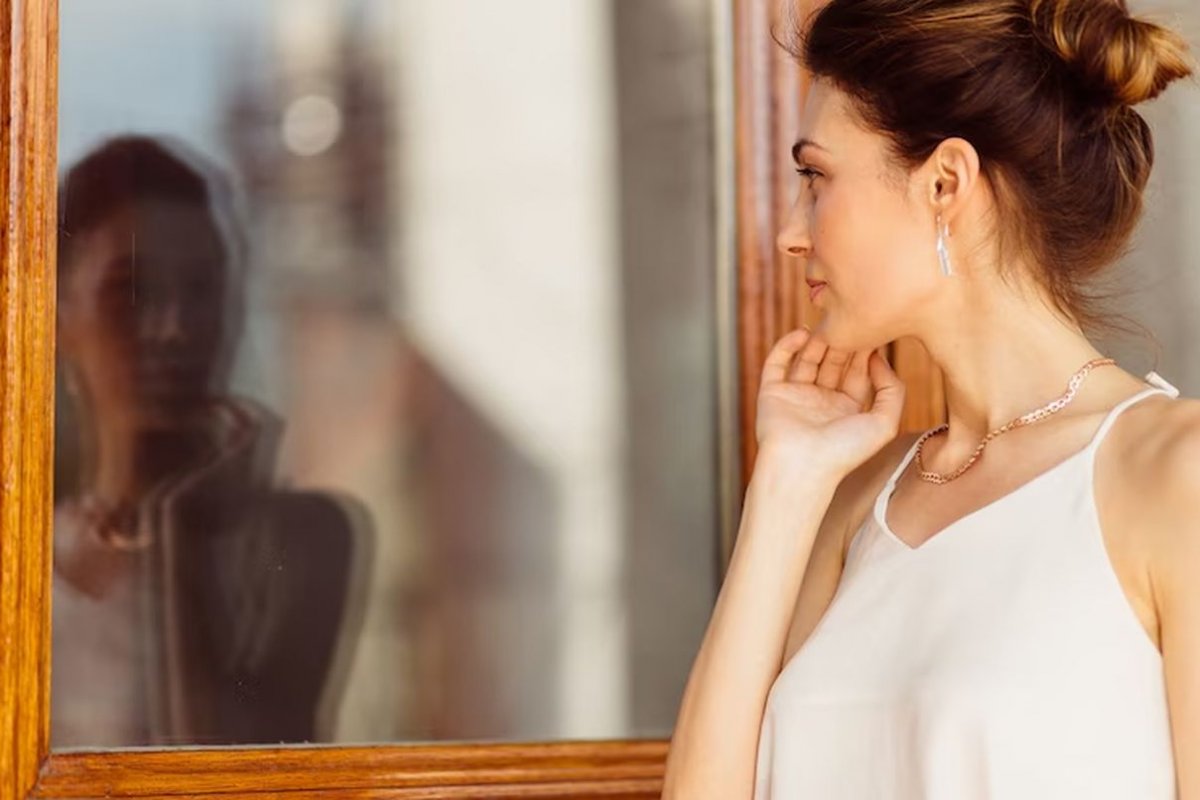 a woman in front of a mirror