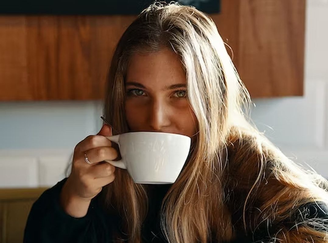 a girl drinks coffee