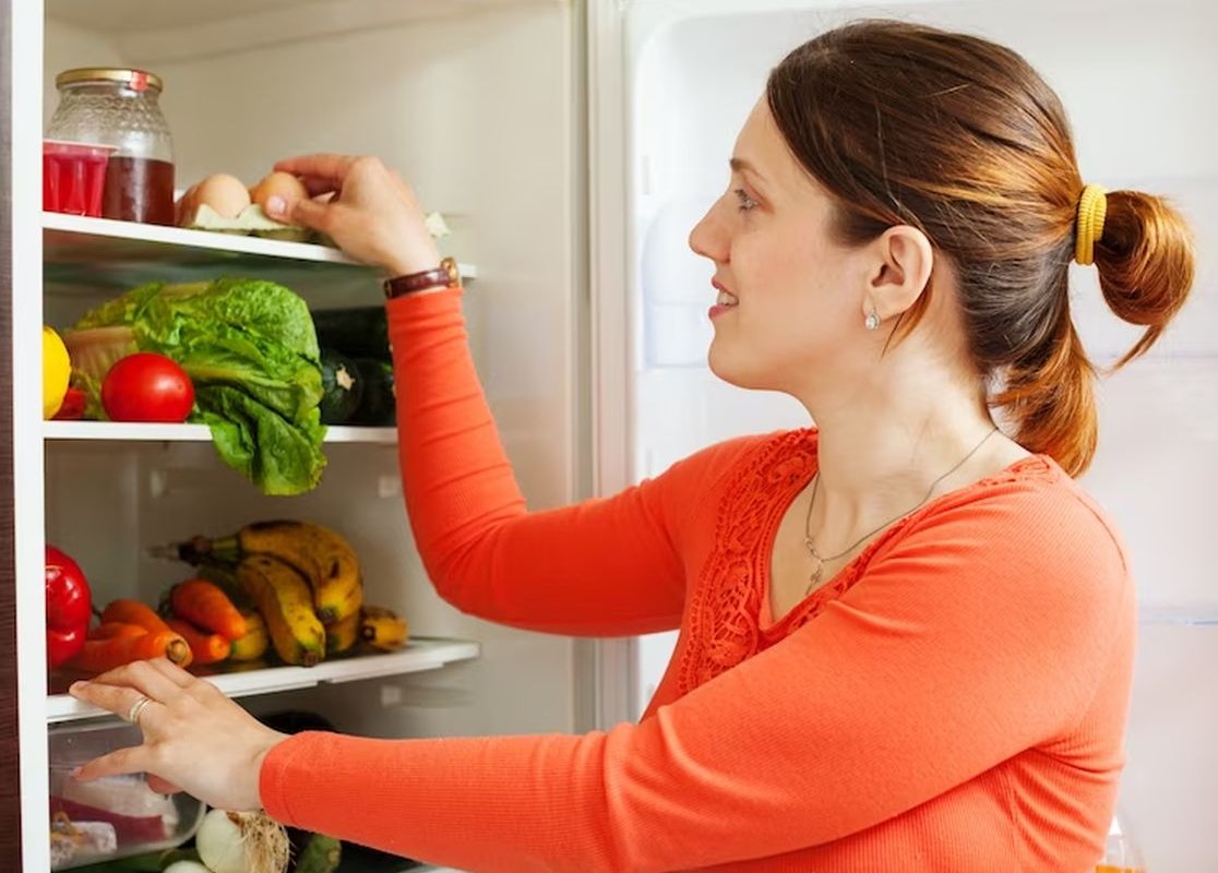 a woman opened the refrigerator