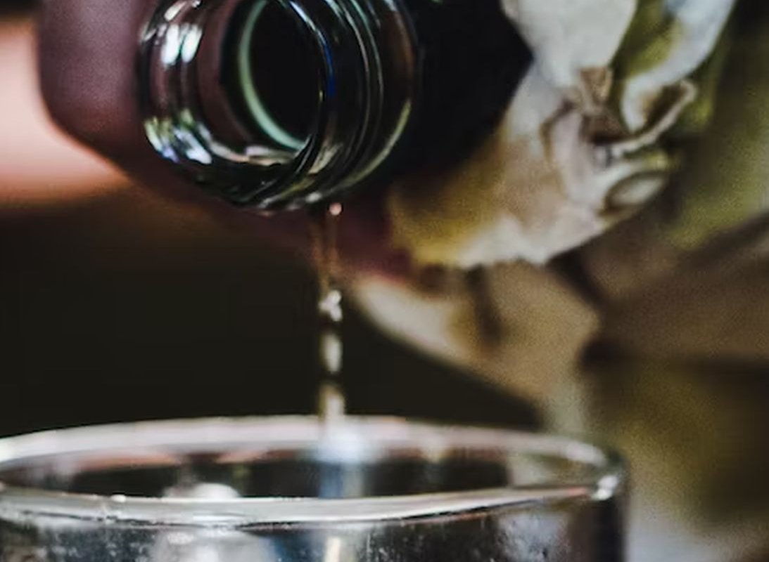 alcohol pours into a glass