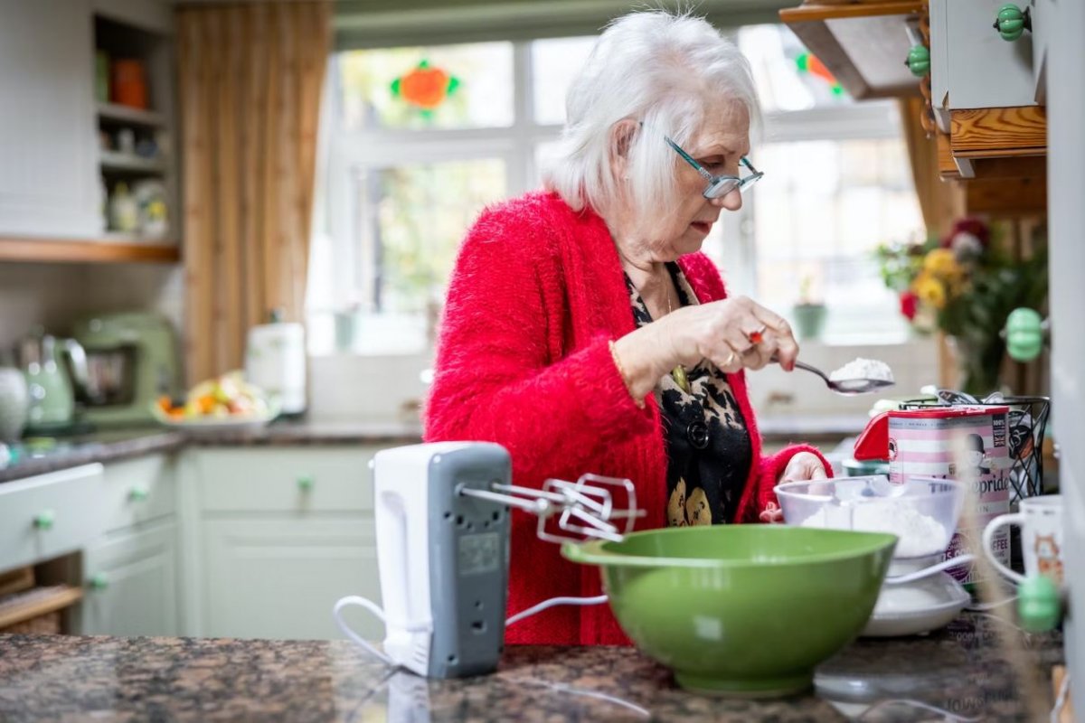 an elderly woman is cooking