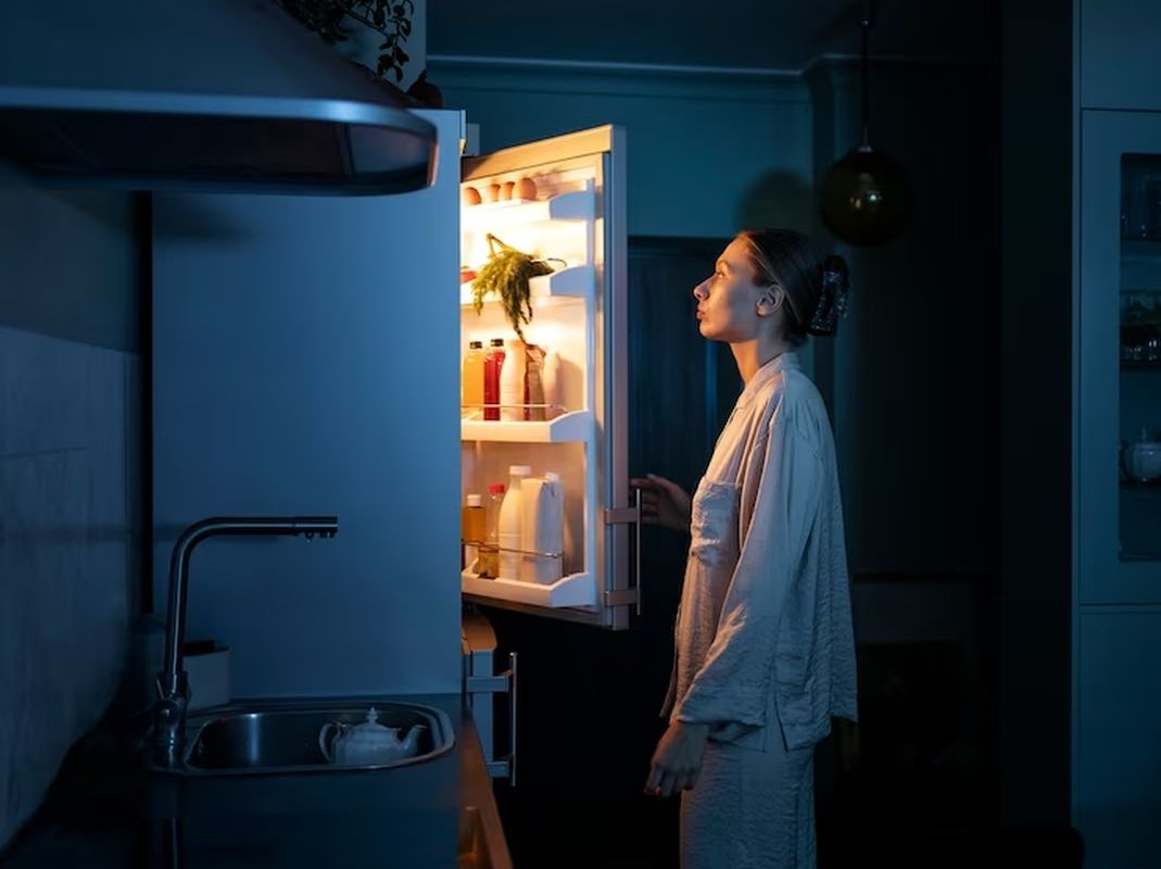 woman at the refrigerator at night