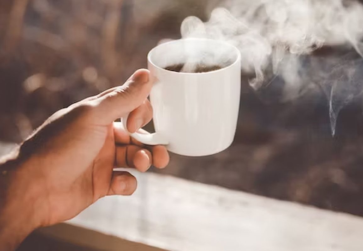 mug with a drink in hand