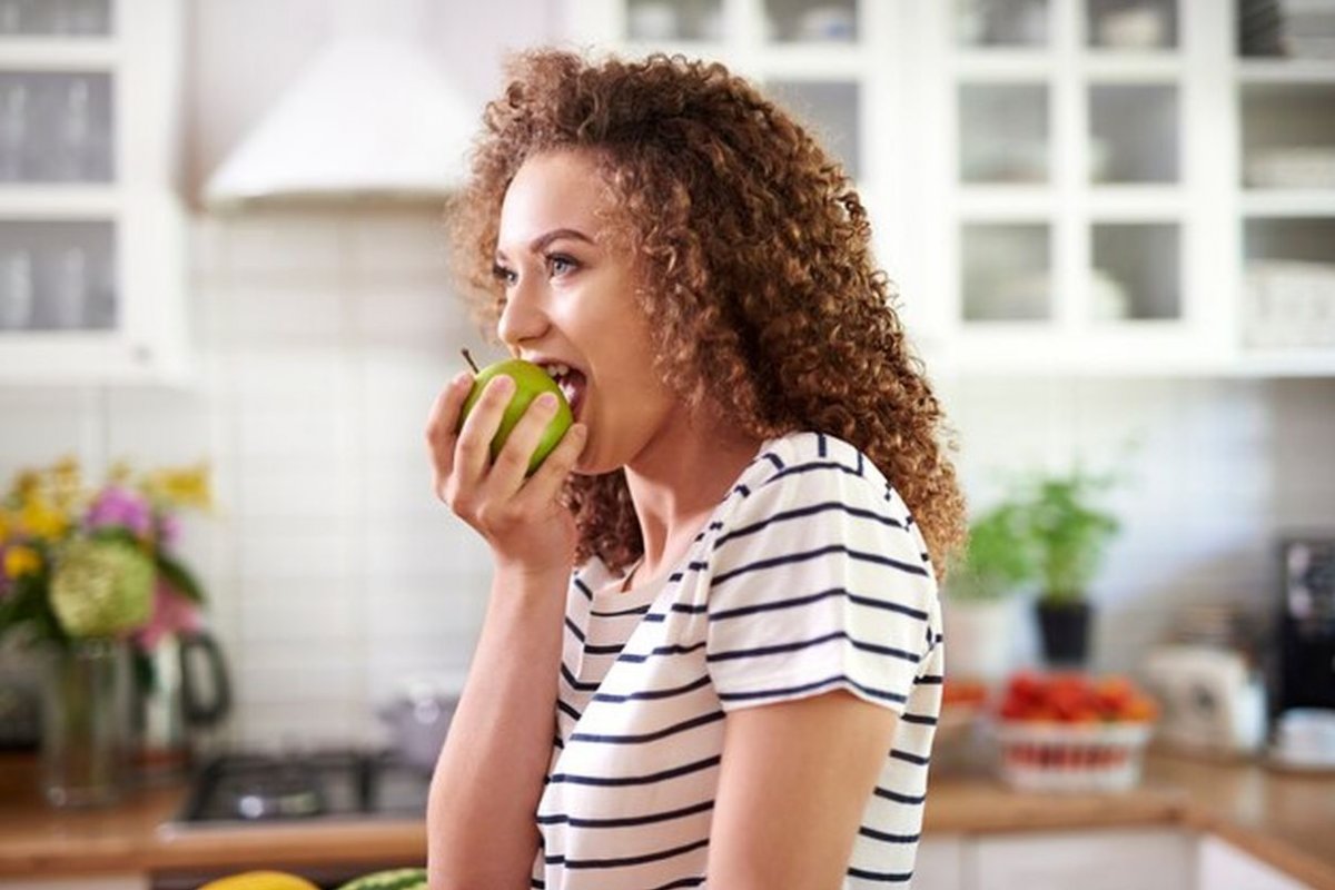 woman eats an apple