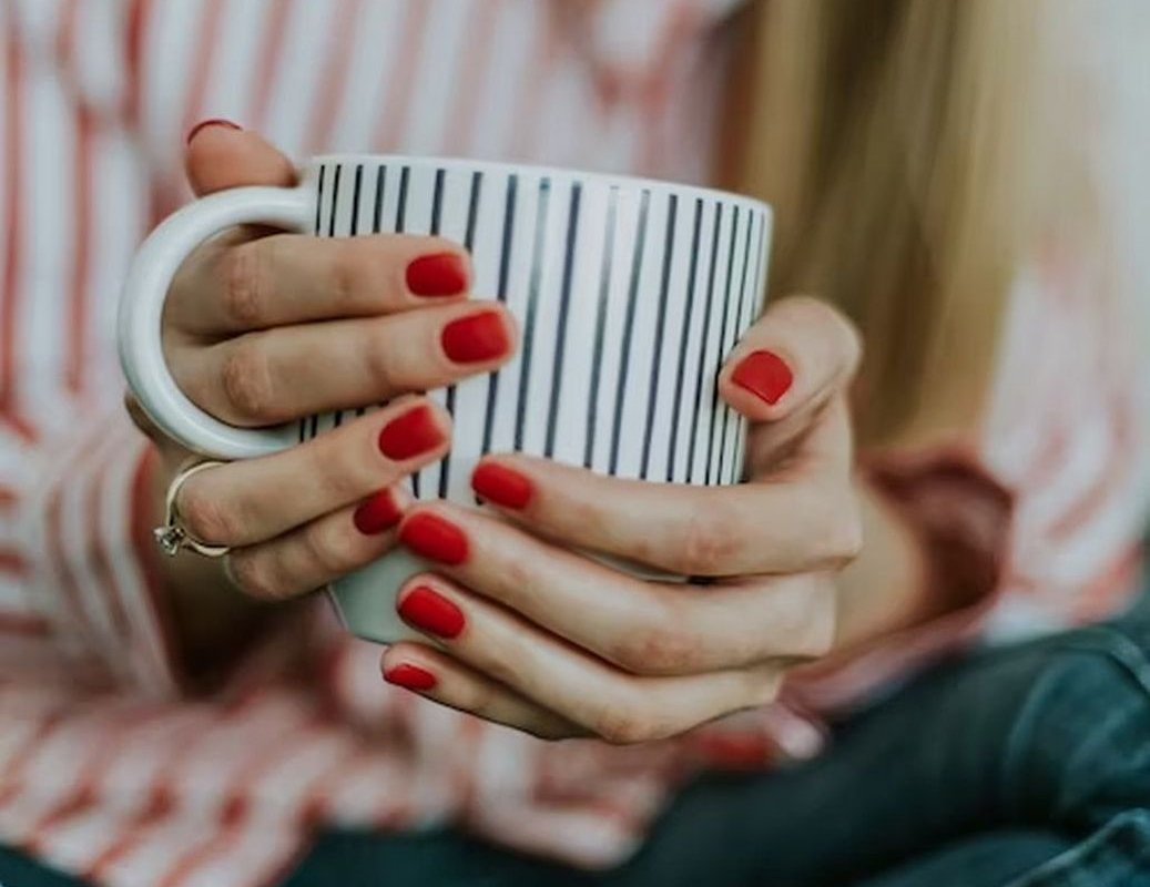 mug with a drink in hand