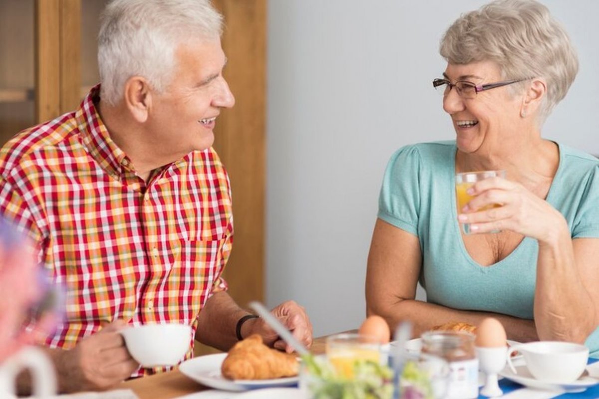 an elderly couple is having lunch