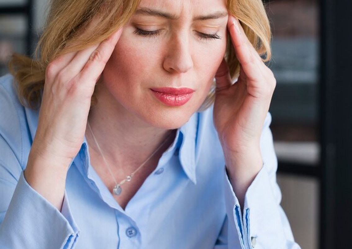 woman holding her head