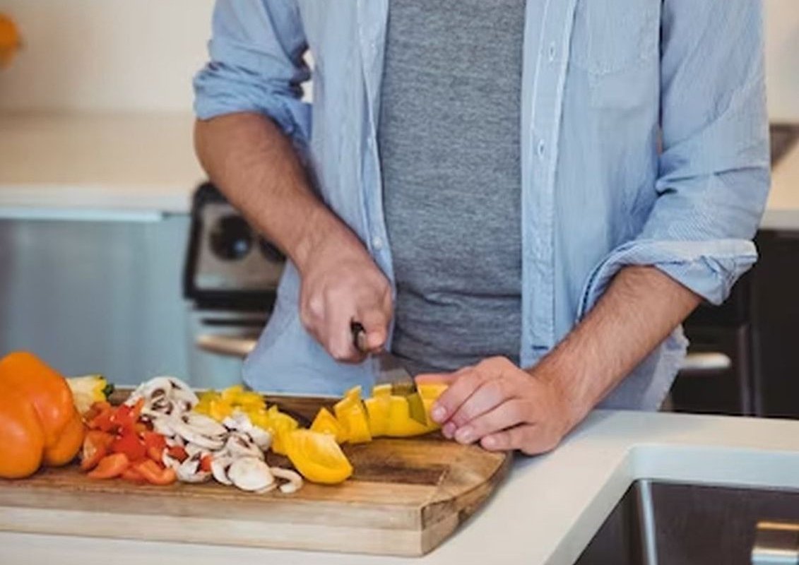 a man cuts vegetables