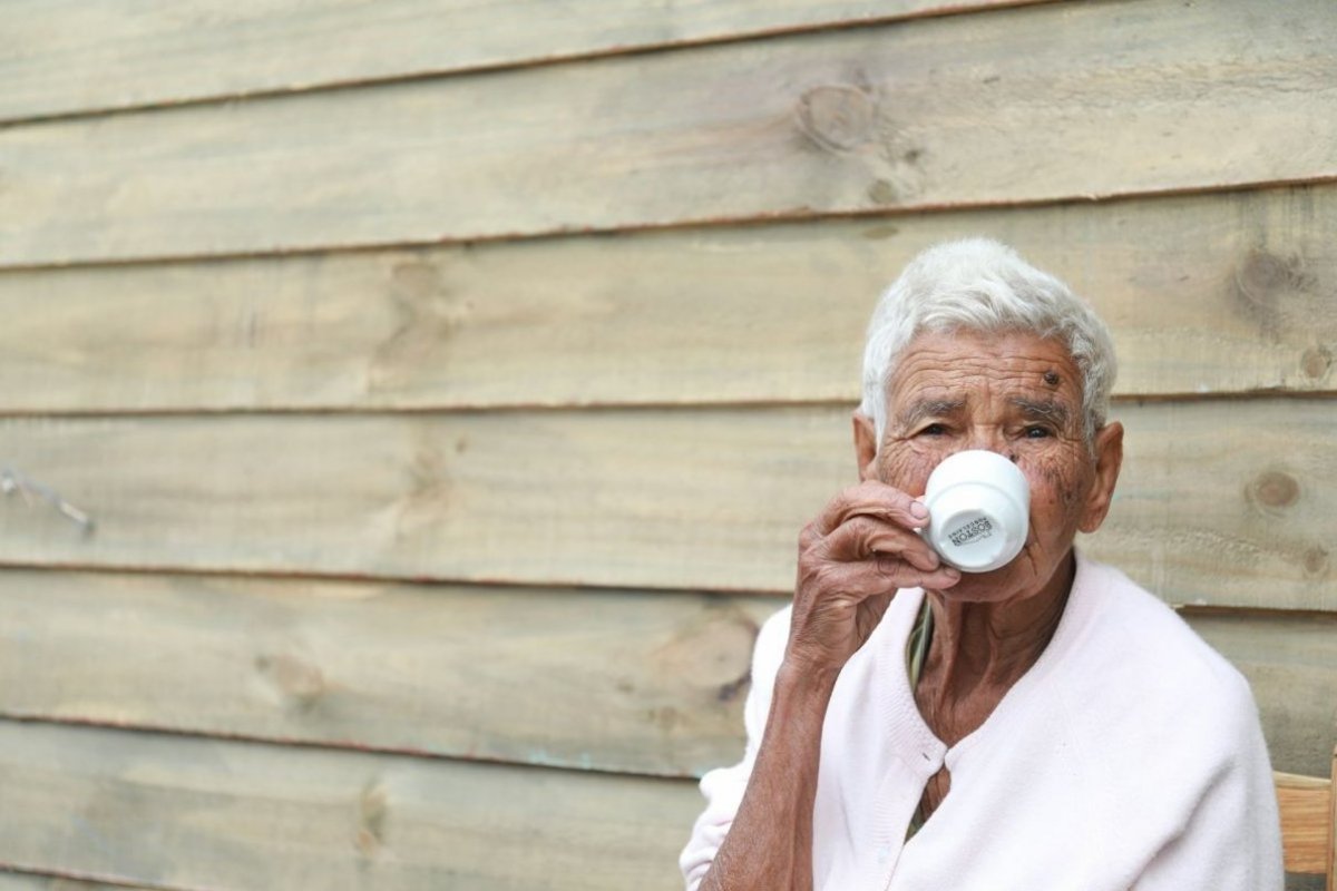 an old man drinks coffee