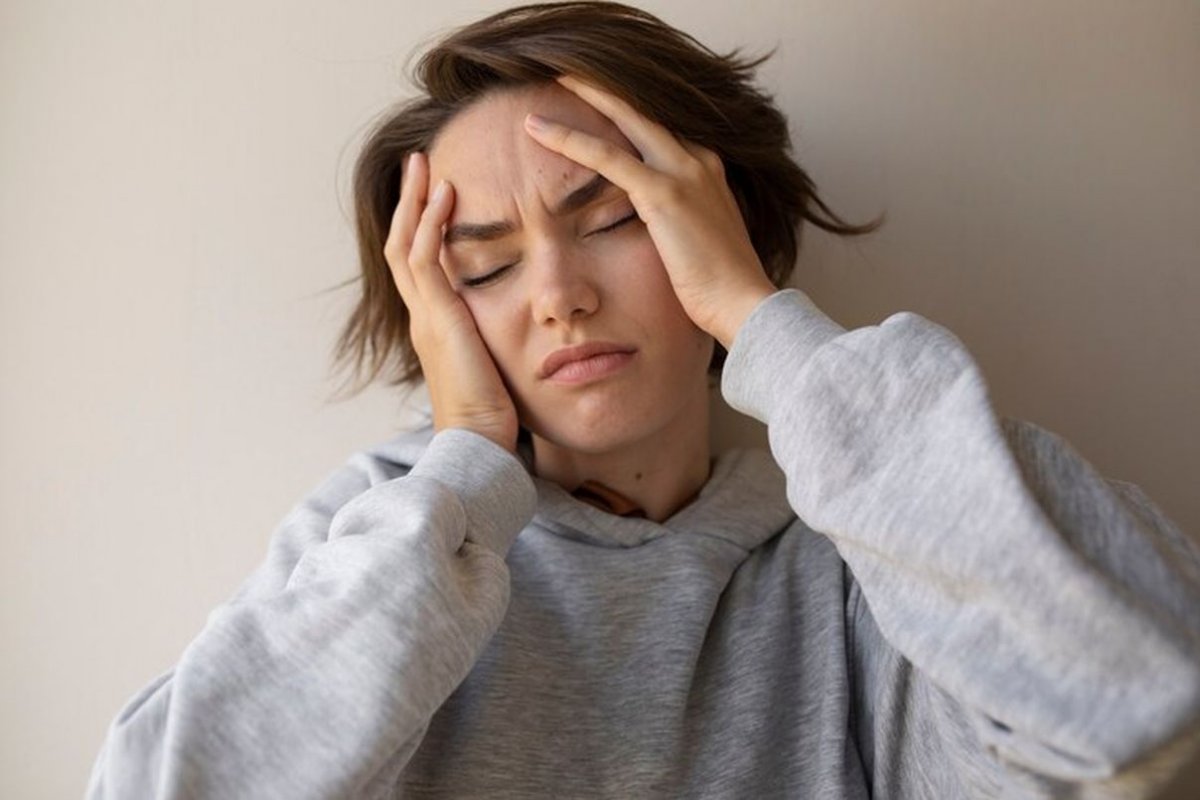 woman holding her head