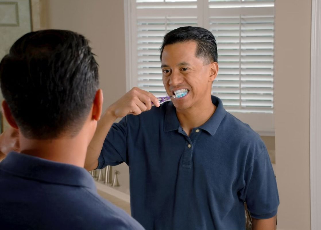 man brushing teeth