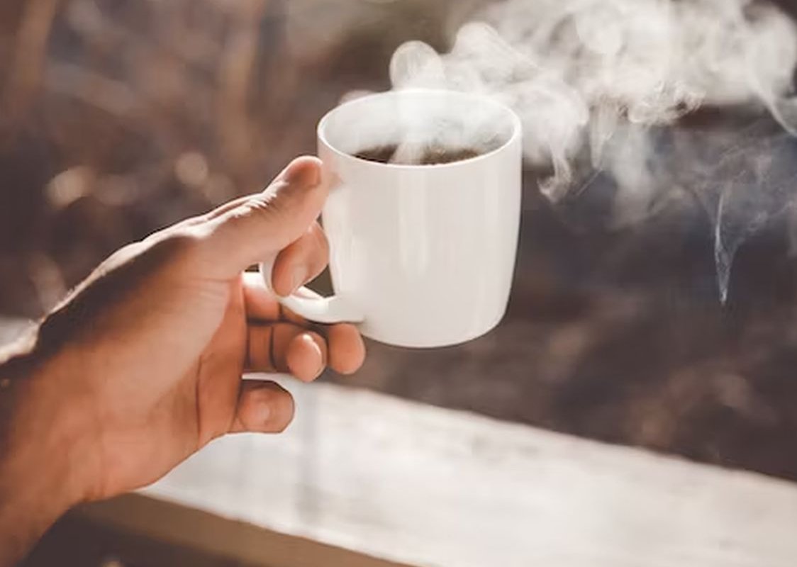 mug with drink in hand